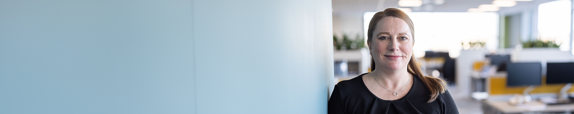 Woman standing smiling in office