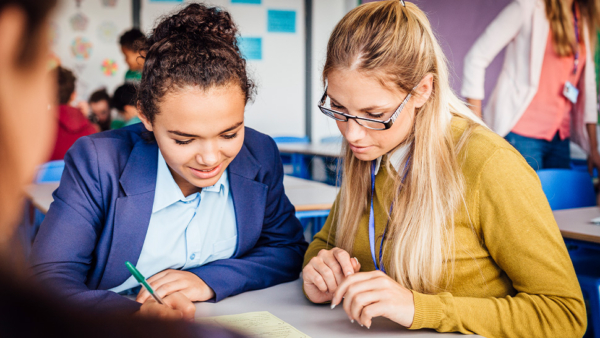 Teacher and student looking at school work together