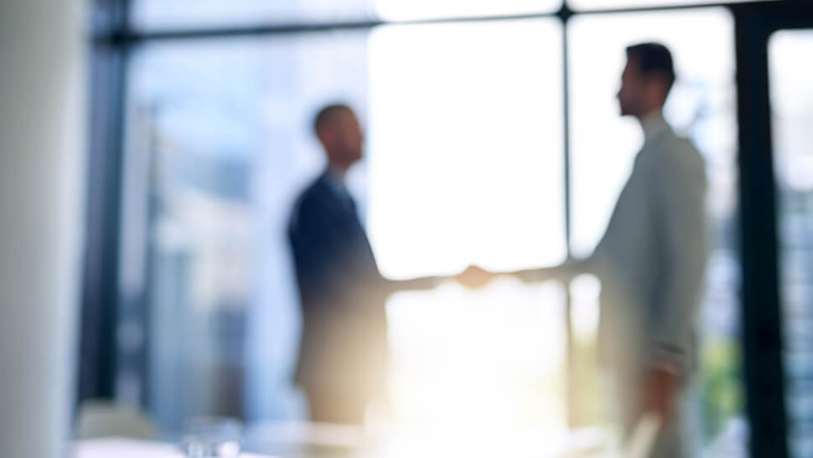 men shaking hands in a meeting room