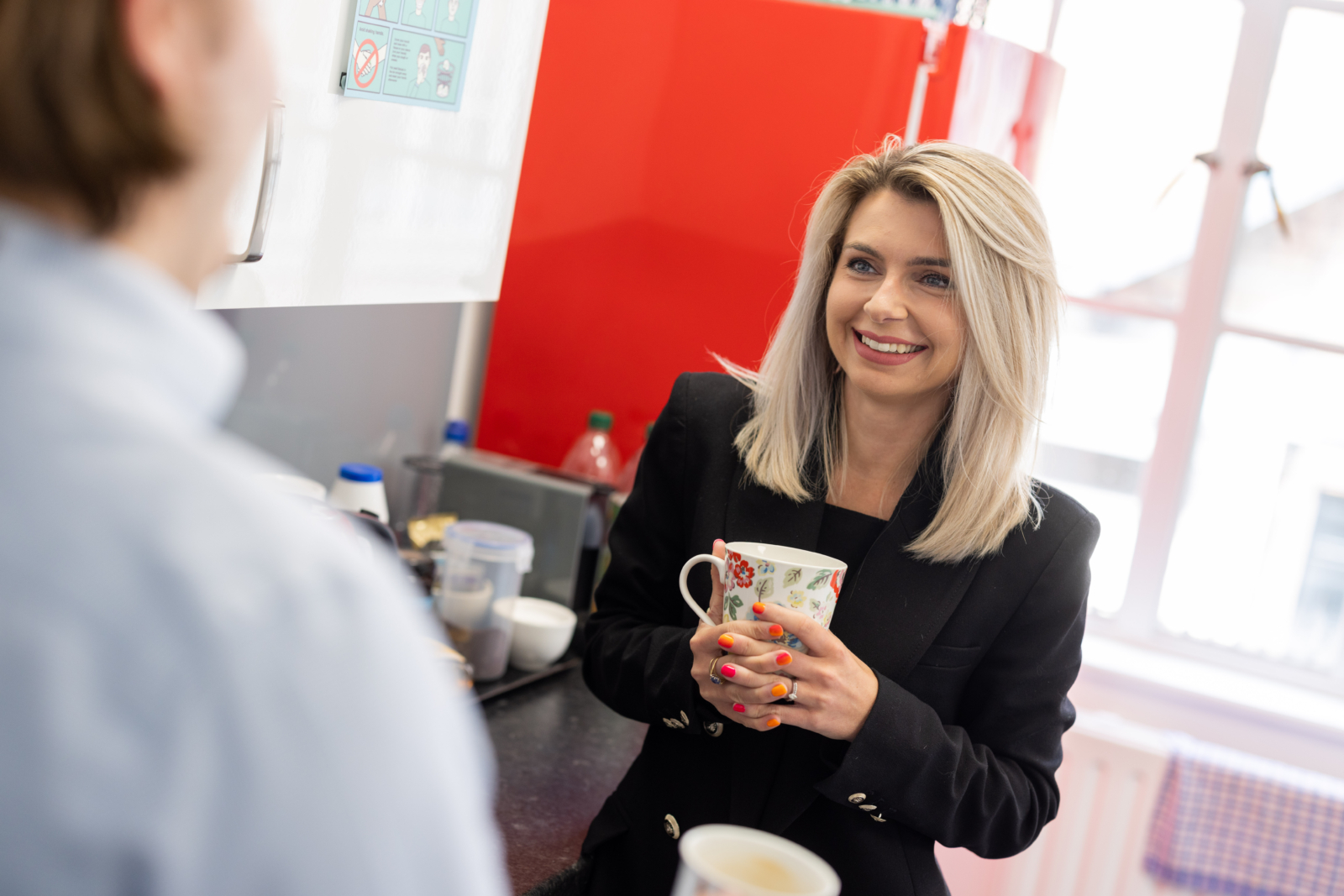 Woman holding mug and smiling