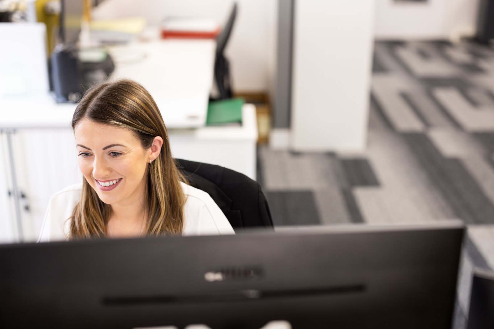 Woman smiling at computer